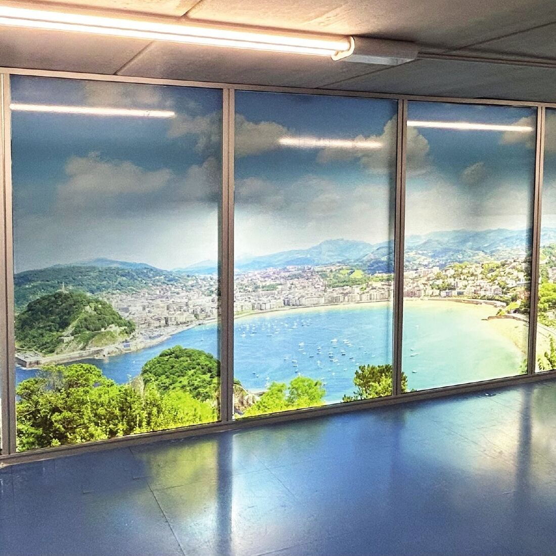 Cerramiento acristalado vinilado con una panorámica de la bahía de La Concha — trabajo de Delta para oficinas